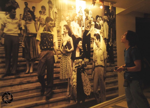 THROWBACK. A man views a still shot from a 1950s movie filmed in UP. Photo by Luis Hidalgo, UP Aperture