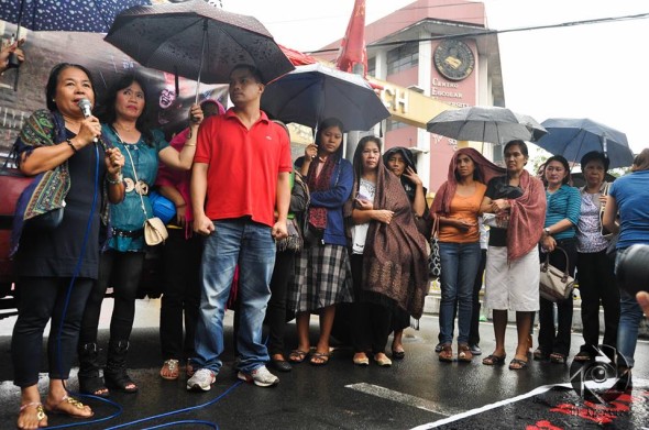 Relatives of the massacre victims speak in front of the Mendiola Peace Arch Saturday to call for justice. Photo by Demerie Dangla, UP Aperture