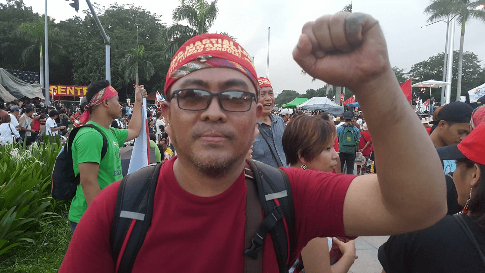 The tribal chief is Kerlan Fanagel. Unlike his companions, he isn’t draped in indigenous patterns. He wears a simple red t-shirt and a matching bandana. Photo: Andrew Mencias